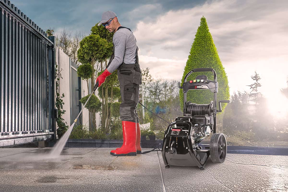 Man using Bimson Power Pressure Washer on driveway